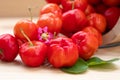 Acerola cherry in wooden bucket on wooden background. Select  focus, Barbados cherry, Malpighia emarginata, high vitamin . Acerola Royalty Free Stock Photo