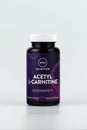 Acetyl L-Carnitine capsules in the jar. dietary supplement vertical editorial photo