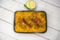 Achari beef khichuri biryani rice pulao with cucumber and lemon slice served in dish isolated on wooden table top view of Royalty Free Stock Photo