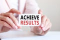 Achieve results written on a card in woman hands Royalty Free Stock Photo