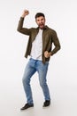 Achievement, success and prize concept. Vertical full-length studio shot pleased and rejoicing male with beard in casual