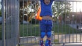 Achievements of child, winner kid raises hands up standing on rollerdrome