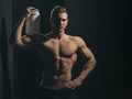 Achieving health and fitness goals. Healthy diet and fitness. Athletic man hold vitamin bottle in strong arms. Man use