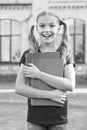 Achieving high standards. Cute little bookworm. Cute smiling small child hold books educational institution background Royalty Free Stock Photo