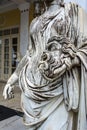 A tragic mask in the hand of Statue of Melpomene, the muse of tragedy, on the balcony of Achillion palace on greek island Corfu in