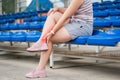 Achilles tendon injury, callus on the heel while running, foot pain, woman suffering from feet ache on a sports ground Royalty Free Stock Photo