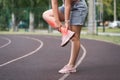 Achilles tendon injury, callus on the heel while running, foot pain, woman suffering from feet ache on a sports ground, podiatry Royalty Free Stock Photo