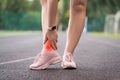 Achilles tendon injury, callus on the heel while running, foot pain, woman suffering from feet ache on a sports ground, podiatry Royalty Free Stock Photo