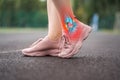 Achilles tendon injury, joint inflammation, foot pain, woman suffering from feet ache on a running track, podiatry concept Royalty Free Stock Photo