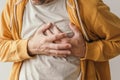 Aching heart and heart attack, adult male with painful grimace pressing the upper abdomen Royalty Free Stock Photo