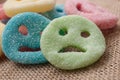 Acidulous candies in shaped smiley on hessian backgro Royalty Free Stock Photo