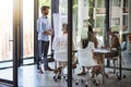 Acing his boardroom presentation. a group of man giving a whiteboard presentation to colleagues in a boardroom. Royalty Free Stock Photo