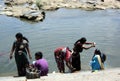 Acitvity by the river in Karnataka, India, washing and praying, and blessing Royalty Free Stock Photo