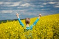 Ack view. Happy smiling boy jumping for joy on a yellow field Royalty Free Stock Photo