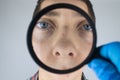 Acne and black dots close-up. A man is being examined by a doctor. Dermatologist examines the skin through a magnifier, a magnifyi