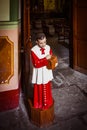Acolyte with donation box for gifts in church