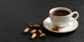 Acorn coffee on a black background. A Cup of black coffee and acorns. Caffeine substitute concept. Copy space Royalty Free Stock Photo