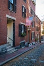 Acorn Street Beacon Hill house during fall harvest with American Flag and cobblestone alley in Boston, Massachusetts Royalty Free Stock Photo