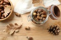 Acorns, oak leaves and pine cone on wooden table, flat lay Royalty Free Stock Photo