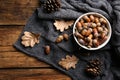 Acorns, oak leaves and pine cones on wooden table, flat lay Royalty Free Stock Photo