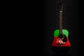 Acoustic concert guitar with a drawn flag Afghanistan, on a dark background, as a symbol of national creativity or folk song