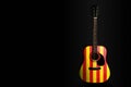 Acoustic concert guitar with a drawn flag Catalonia, on a dark background, as a symbol of national creativity or folk song