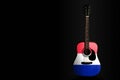 Acoustic concert guitar with a drawn flag France, on a dark background, as a symbol of national creativity or folk song