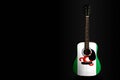 Acoustic concert guitar with a drawn flag Ingushetia, on a dark background, as a symbol of national creativity or folk song