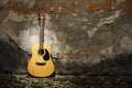 Acoustic guitar against grungy wall Royalty Free Stock Photo