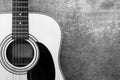 Acoustic guitar on the background of a concrete wall close-up, monochrome Royalty Free Stock Photo