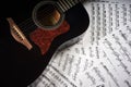 Acoustic guitar on a background sheet notes Royalty Free Stock Photo