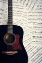 Acoustic guitar on a background sheet notes Royalty Free Stock Photo