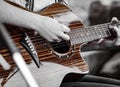 An acoustic guitar being strummed