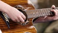 An acoustic guitar being strummed