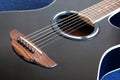 Acoustic guitar with black top with six strings closeup Royalty Free Stock Photo