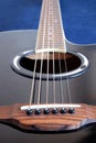 Acoustic guitar with black top with six strings closeup Royalty Free Stock Photo