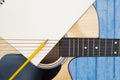 Acoustic guitar on blue background, The guitar body pattern is wood grain.