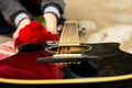 Acoustic guitar and bouquet of red roses Royalty Free Stock Photo