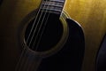 Acoustic guitar close up.Guitar.Acoustic guitar chords in the dark with some white light on the top left.Playing guitar with frien