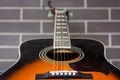 Acoustic guitar closeup over brick wall Royalty Free Stock Photo