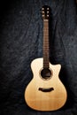 An Acoustic Guitar on dark Cloth Background Royalty Free Stock Photo