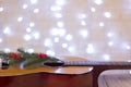 Guitar decorated with a branch of a Christmas tree and lighted g Royalty Free Stock Photo