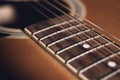 An acoustic guitar detail with dark vignette