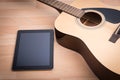 Acoustic guitar with digital tablet Royalty Free Stock Photo