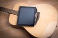 Acoustic guitar with digital tablet Royalty Free Stock Photo