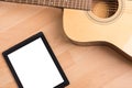 Acoustic guitar with digital tablet Royalty Free Stock Photo