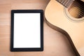 Acoustic guitar with digital tablet Royalty Free Stock Photo