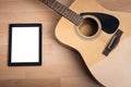 Acoustic guitar with digital tablet Royalty Free Stock Photo