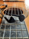 Acoustic Guitar and earphones. Retro style guitar and a earphones. Royalty Free Stock Photo