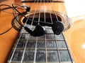 Acoustic Guitar and earphones. Retro style guitar and a earphones. Royalty Free Stock Photo